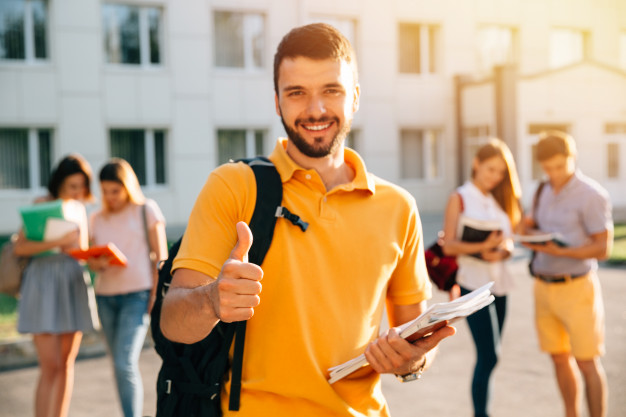 young-attractive-smiling-student-showing-thumb-up-outdoors-campus-university_8353-6394